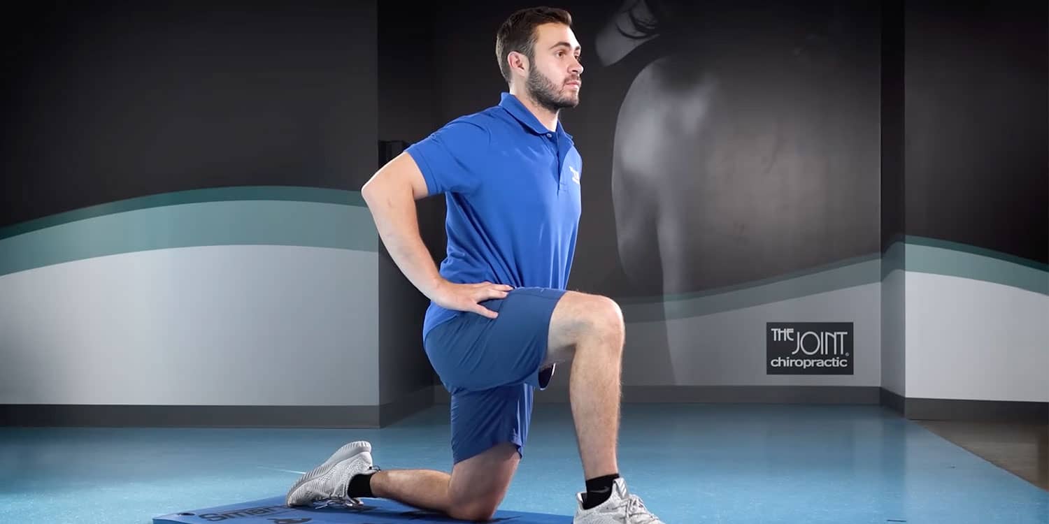 Person performing a hip flexor lunge to ease lower back stiffness and improve hip mobility.